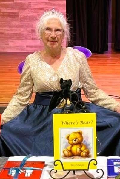Photo of Bess Sturgis kneeling with books